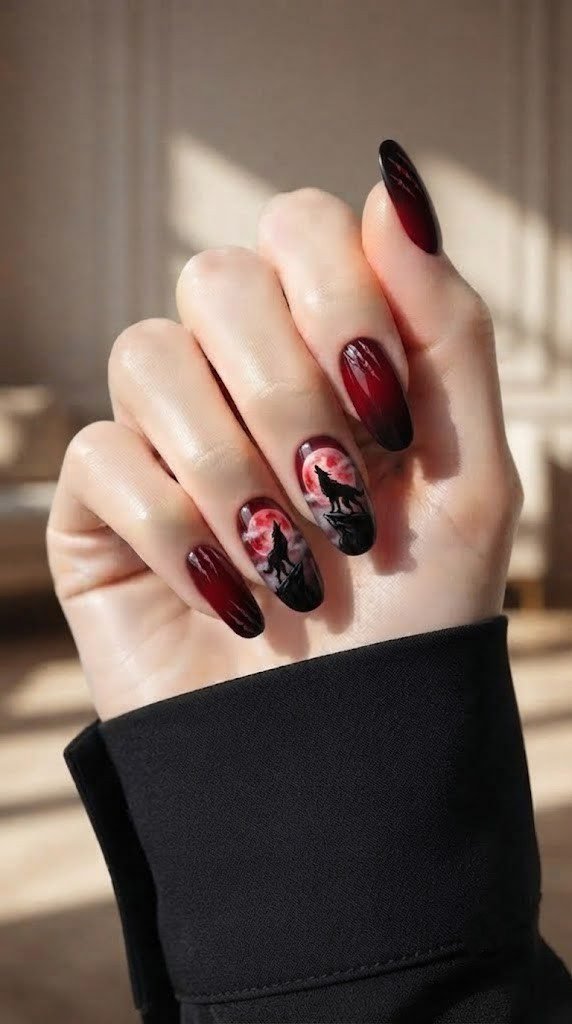 Red Halloween nails with a glowing moon and howling werewolf silhouette accent
