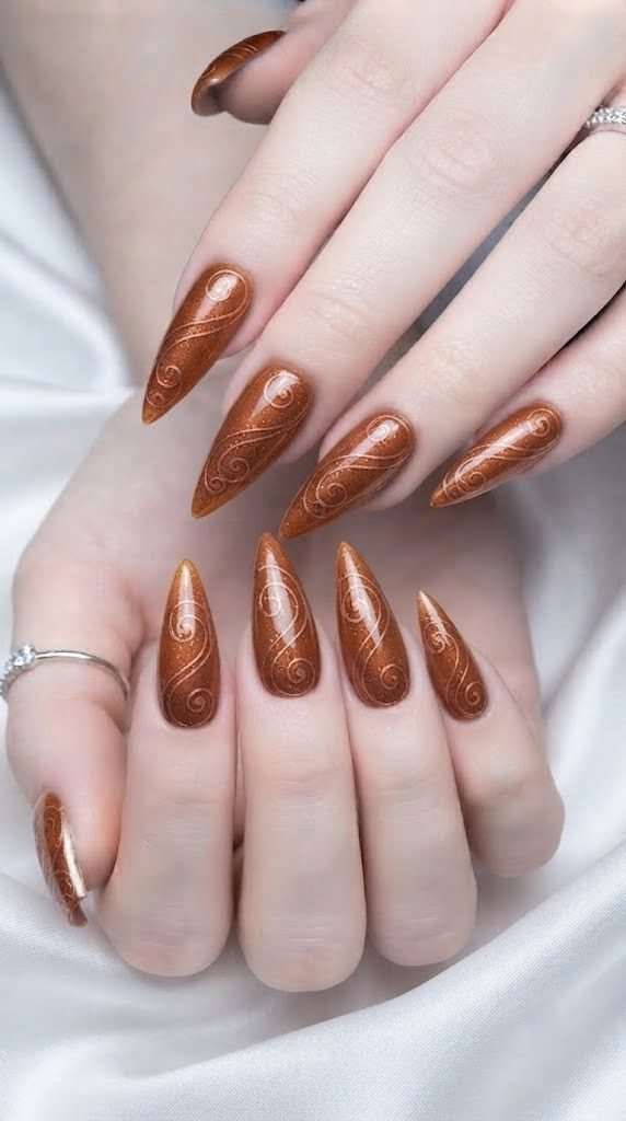 fall stiletto nails in cinnamon bronze with spice swirl linework