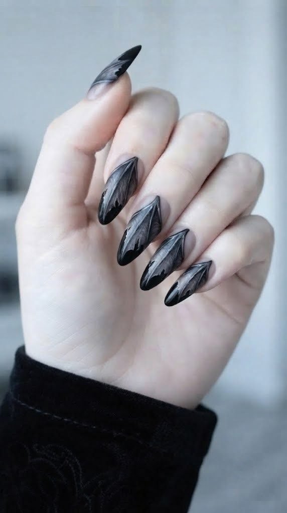vampire nails styled as sharp black claws with torn bat wing membrane