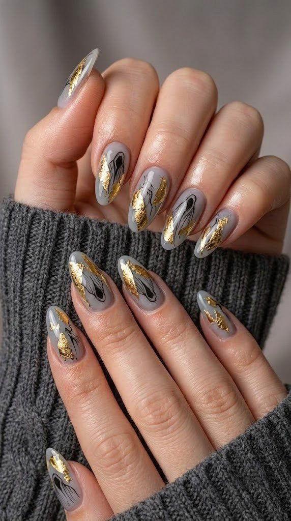 Pale grey November nail designs with gold leaf shards and ghosts