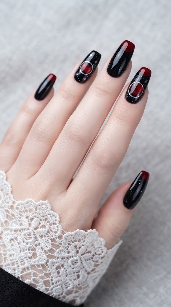 Black Halloween nails with a blood moon eclipse and silver star flecks
