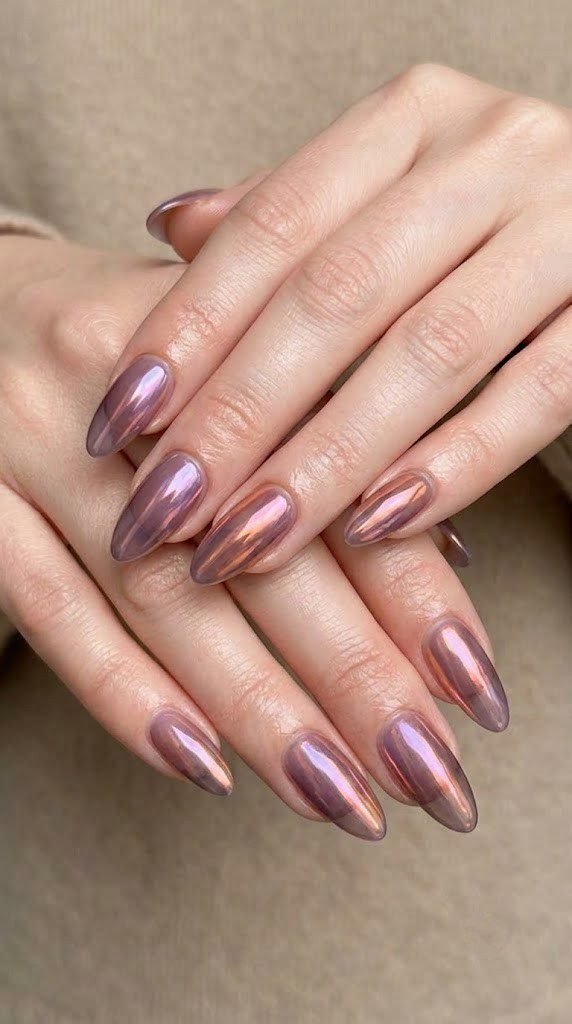 Smoky plum almond nails glazed in an aurora chrome shifting violet to copper