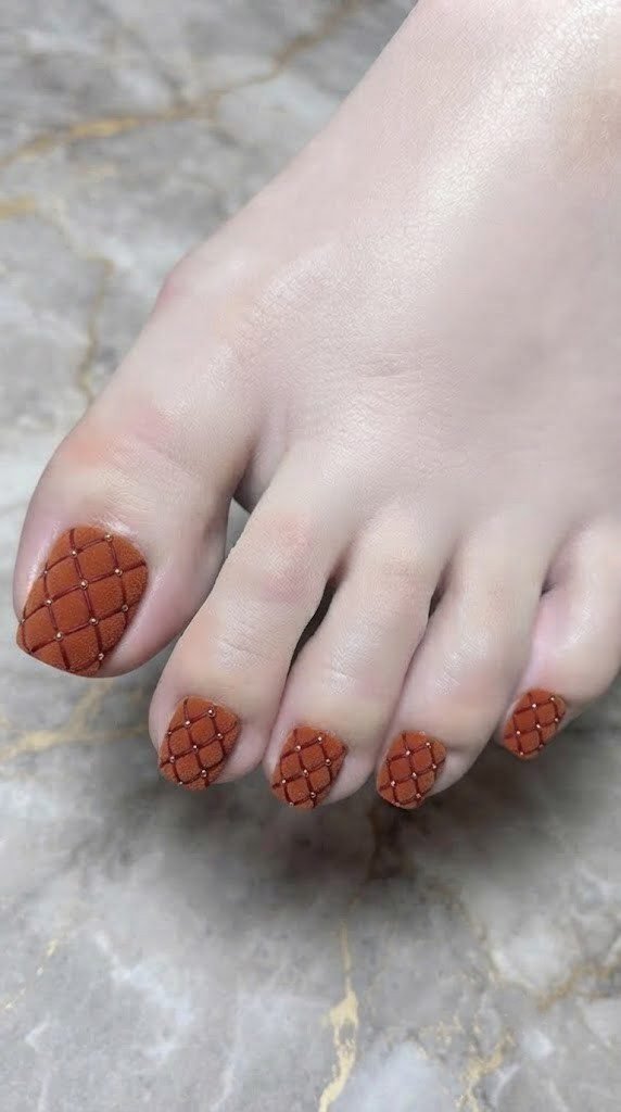 Quilted diamond tuft toe nail art in matte burnt orange velvet