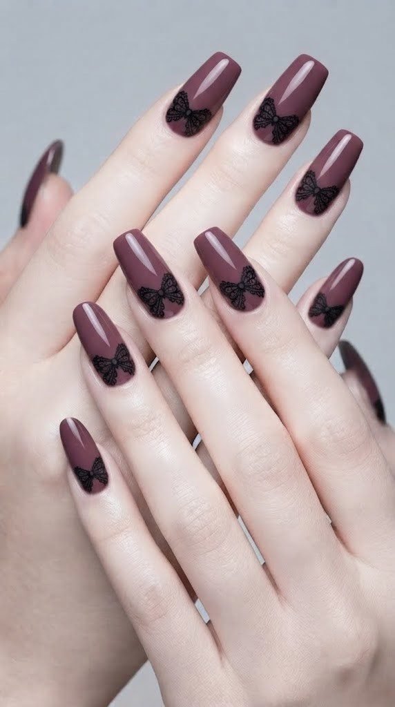 gothic vampire nail designs with a lace bow in glossy plum