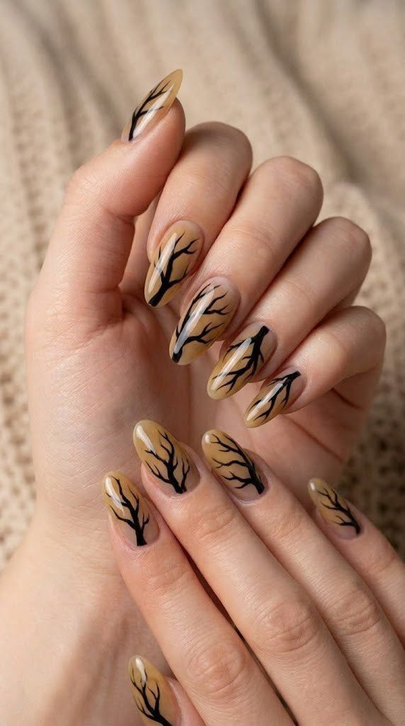 Ochre fall almond nails with blackened, skeletal tree branches