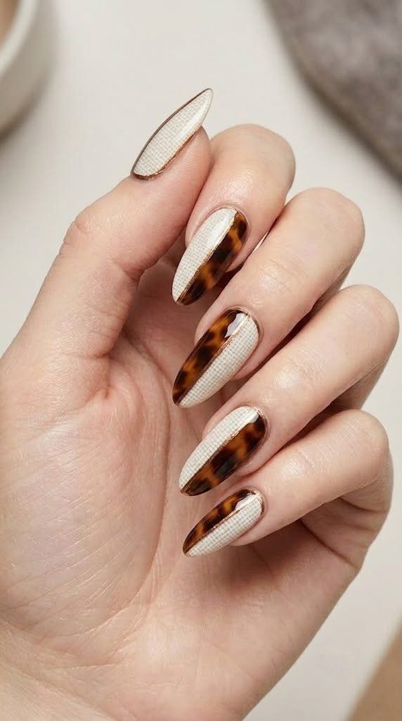 Woven linen print meets a diagonal tortoiseshell split lined in bronze, bold minimalist nail art.