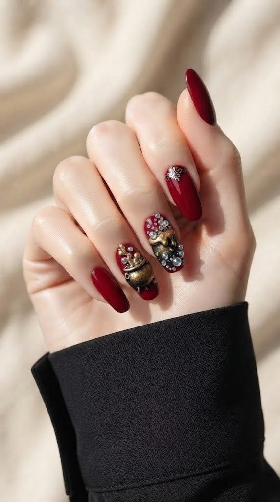 Crimson nails with a bubbling gold and black cauldron accent design