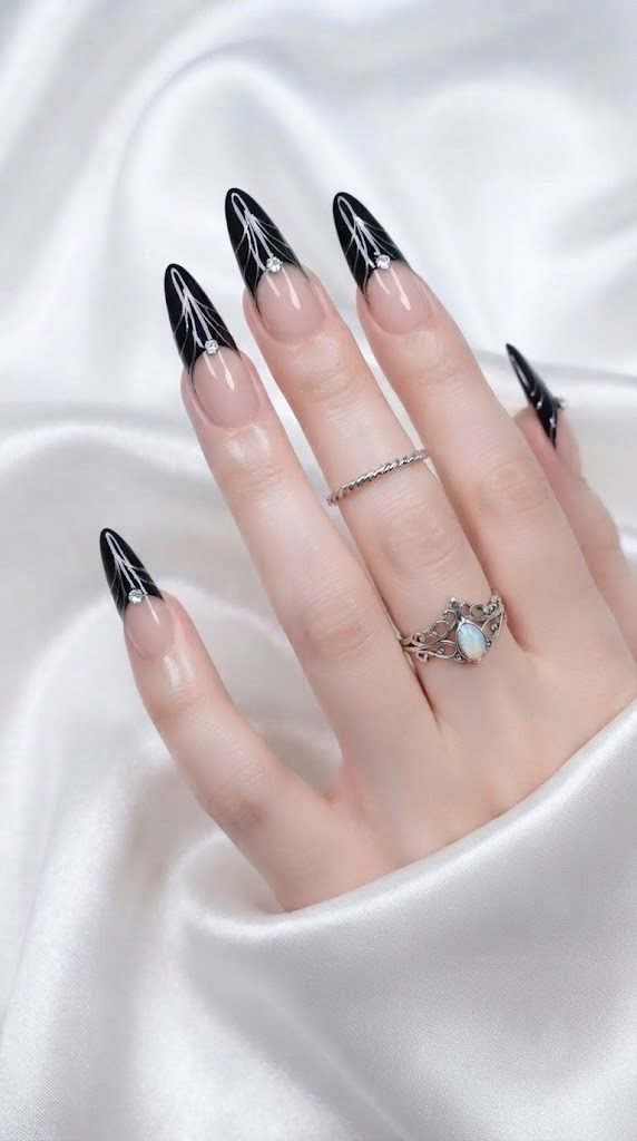 Onyx chrome bat wing tip styled as elegant black Halloween nails