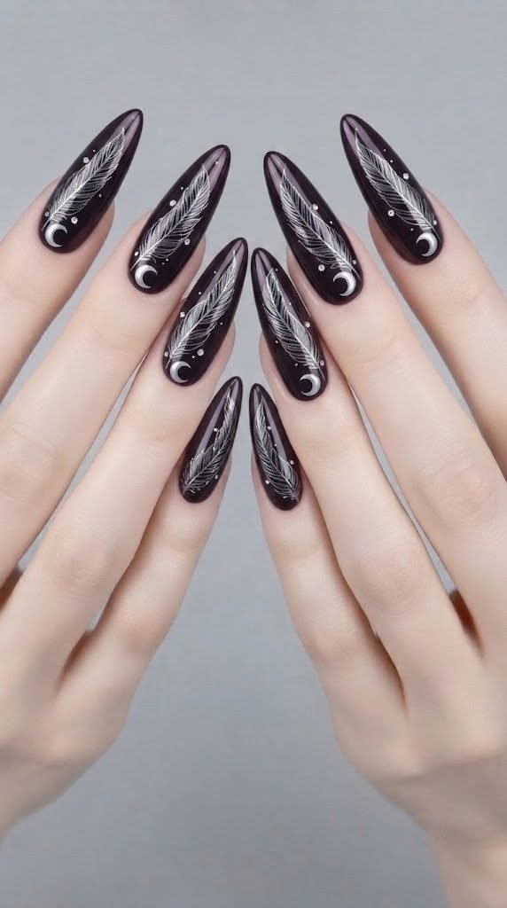 Deep plum almond nail art with a silver chrome raven feather