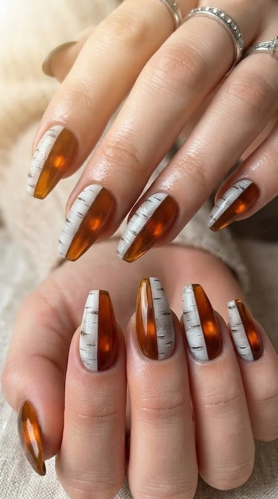 Amber resin and matte birch bark contrast in fall nail design with two finishes