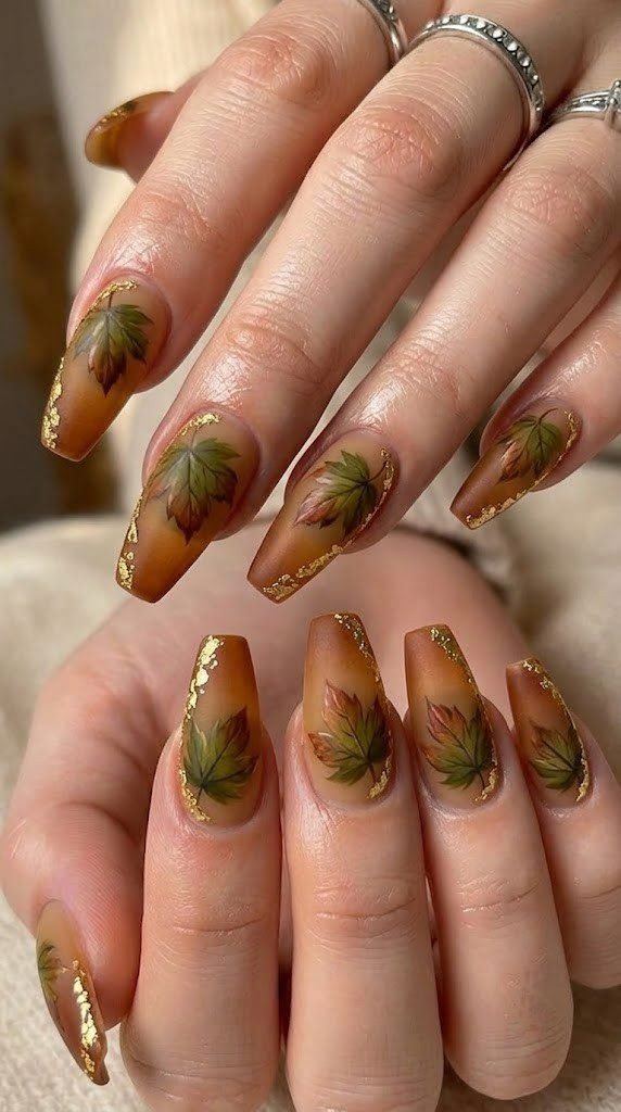 Amber fall nail design with hand-painted sycamore leaves and gold leaf accents
