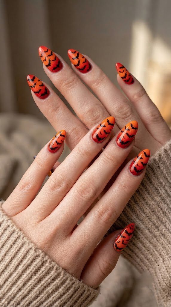 Bat swarm ombre almond orange and black nails with gradient wing detail
