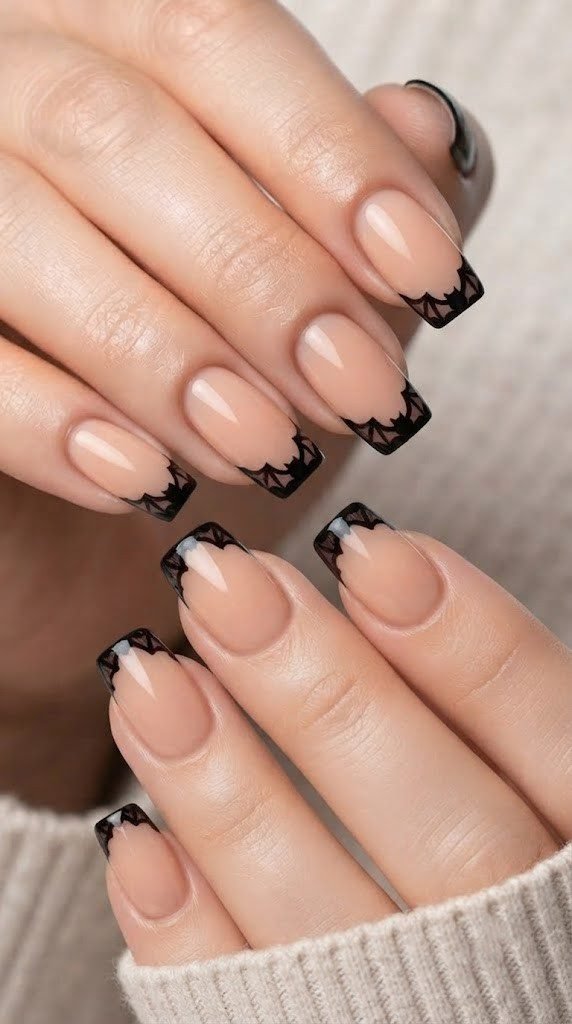 Sheer peach nude coffin nails with scalloped black bat wing french tips