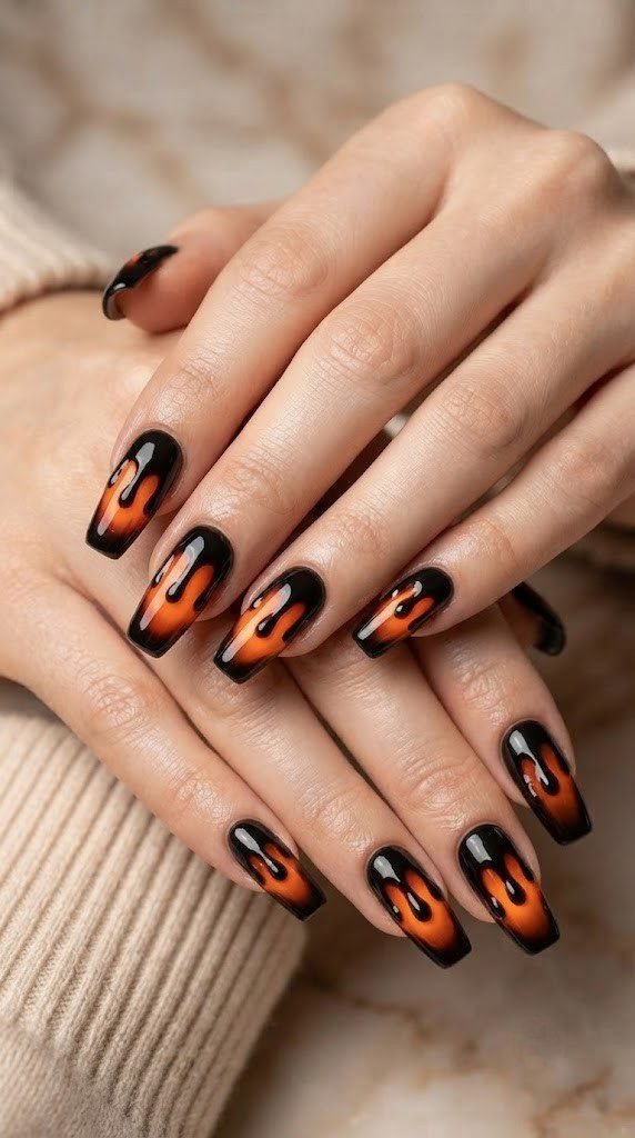 Black and orange halloween nails with a poisoned candy apple coffin design