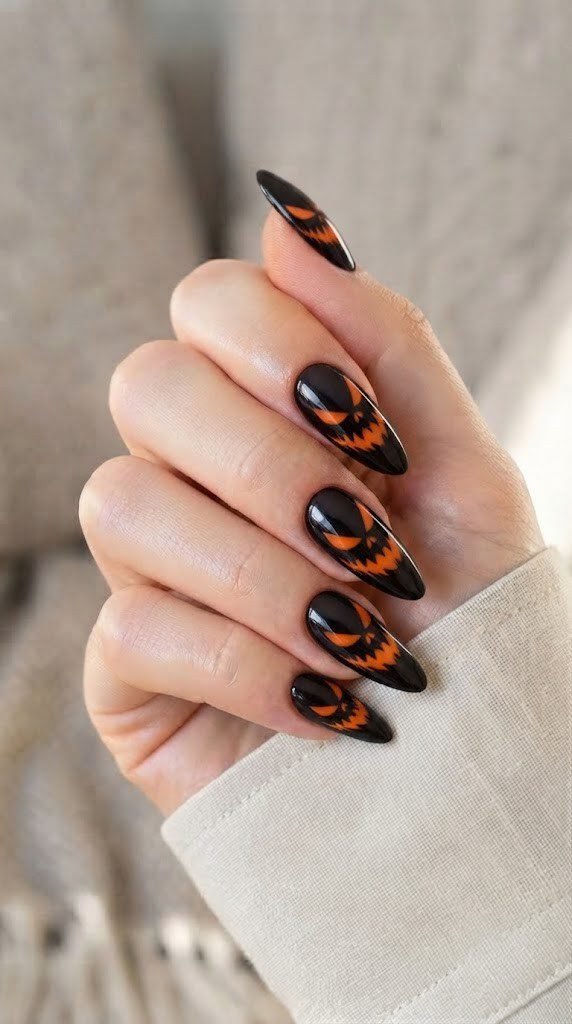 Black and orange halloween nails with an abstract Cheshire grin design