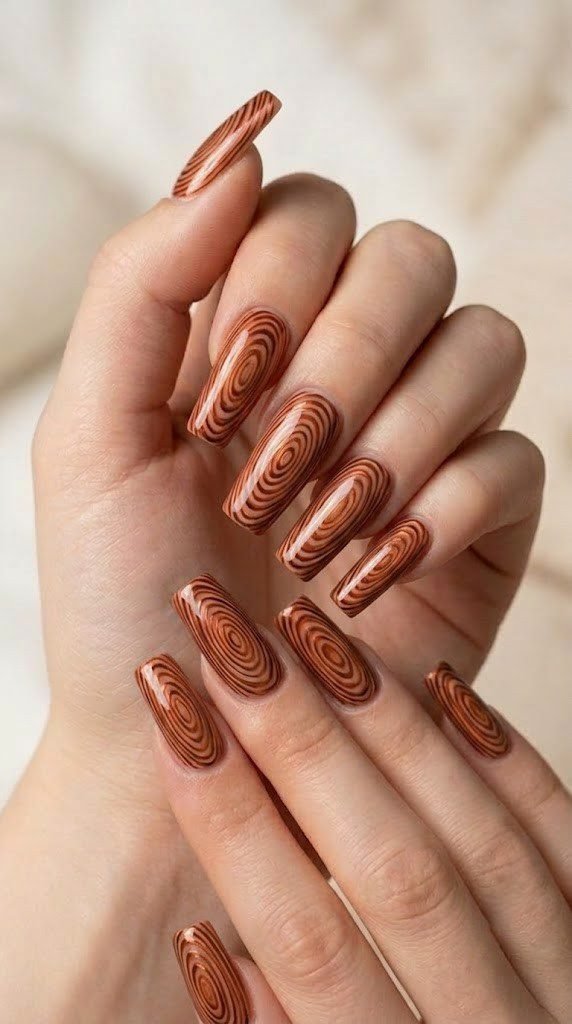 Copper woodgrain pattern fall nail design on square-shaped nails