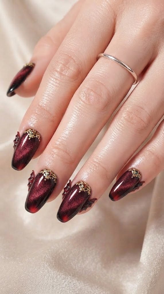 Burgundy coffin acrylic Halloween nails with gold brooch and bat wing texture