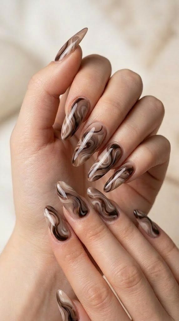 Taupe and espresso swirl abstract fall nail design on almond nails