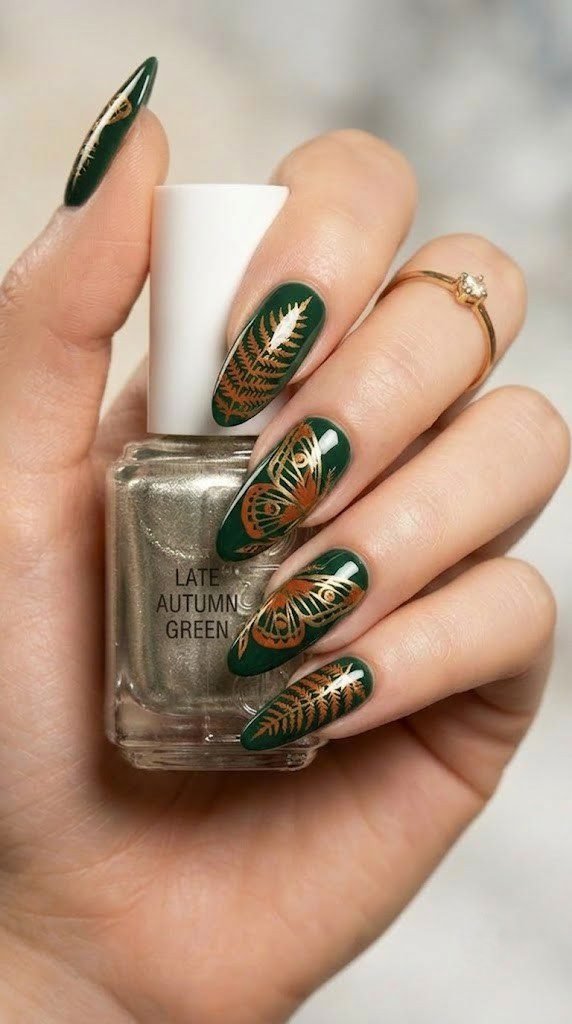 Deep forest green nails with skeletal ferns and burnt orange emperor moth wings