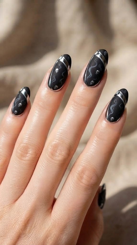 Velvet black nails with a chrome scythe blade, bold short Halloween nail designs