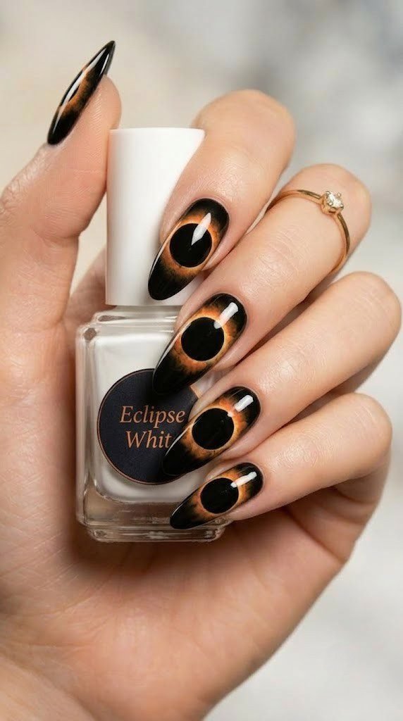 Jet black nails with a glowing orange solar eclipse illustration on every nail