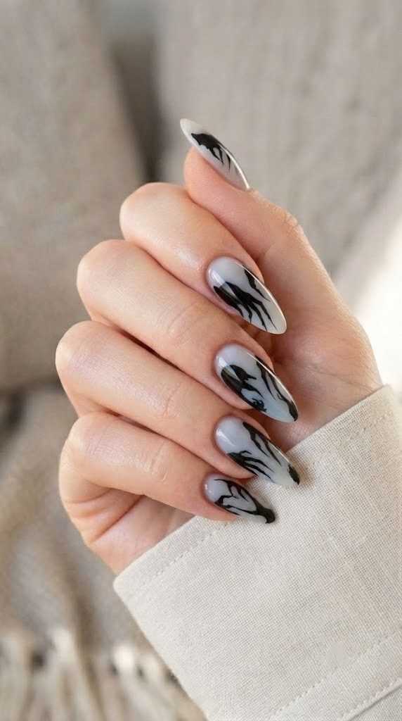Ash-white halloween nails with elongated vampire shadow silhouettes