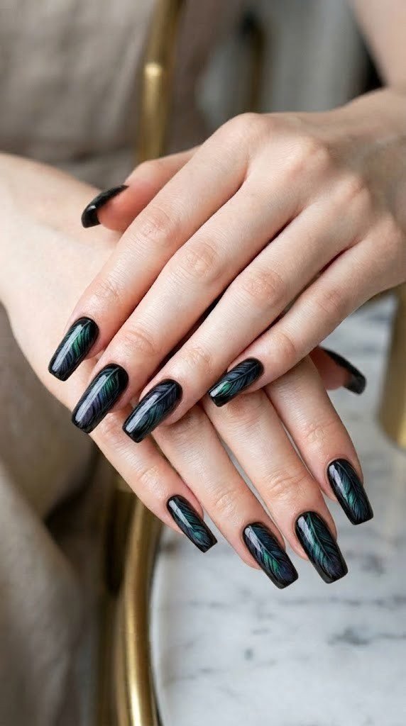 Glossy black fall nail design with iridescent raven feather detailing