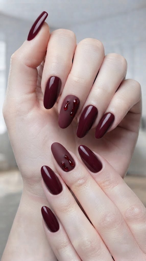 Matte wine Halloween nail design with one glossy crimson drip accent nail
