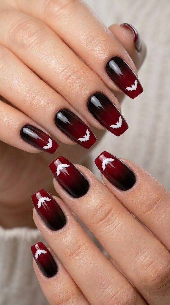 Crimson ombré halloween nail art with tiny white bat accents