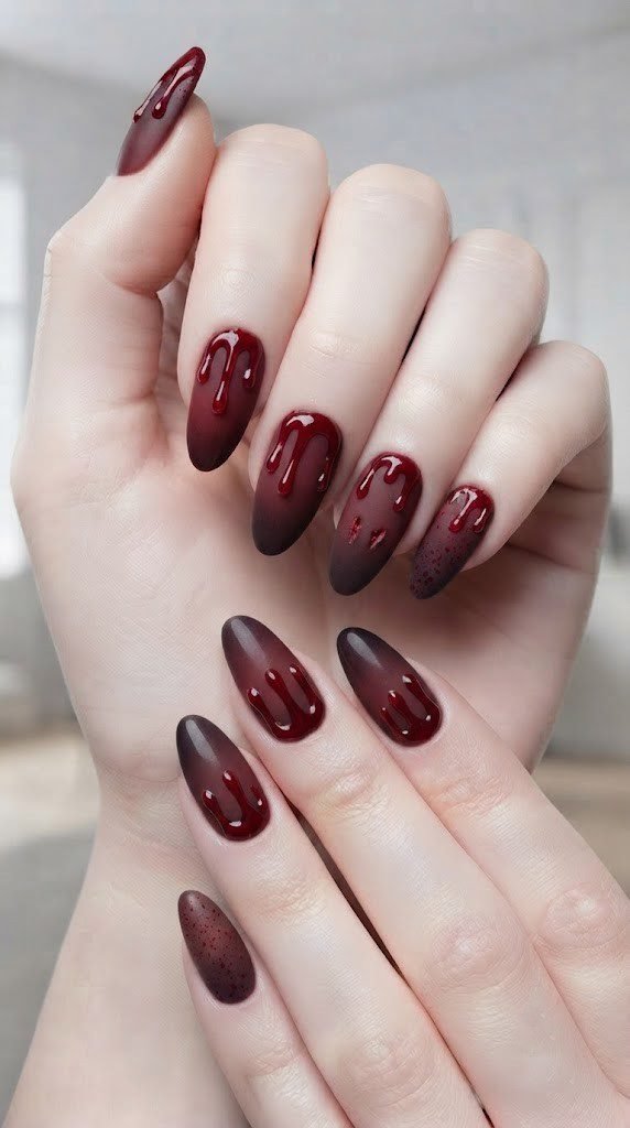 Dripping crimson vampire bite Halloween nails on a wine-burgundy base