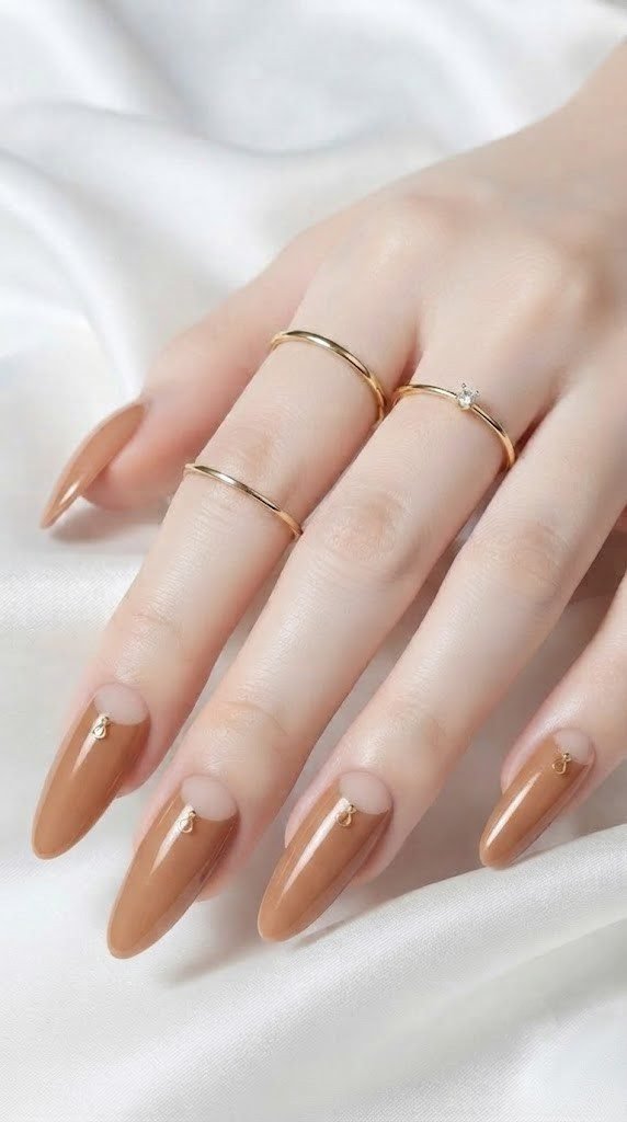 Almond simple fall nails with caramel chrome and a sheer nude crescent moon